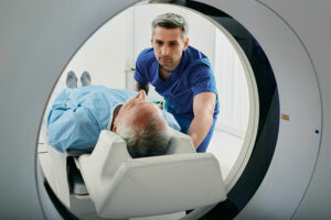 An older man is entering an MRI machine, one of many potential medical tests for older adults.