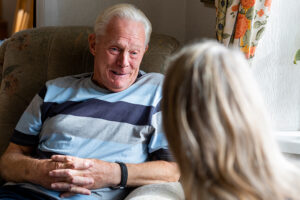 A woman utilizes a creative dementia care strategy with an older man.