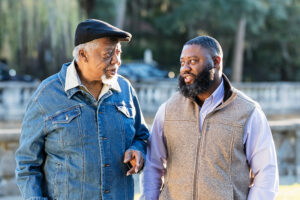 A man uses Parkinson’s communication tips to connect with his father as they walk through the park.