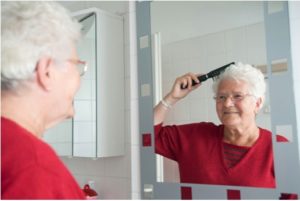 elder woman brushing her hair