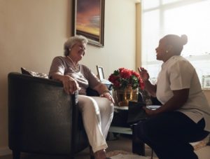 caregiver talking with senior woman
